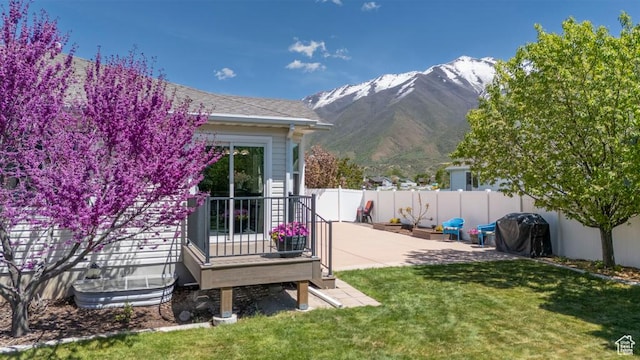 view of yard with a mountain view and a patio area