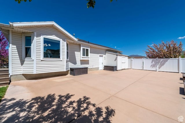 rear view of house featuring a patio area and fence
