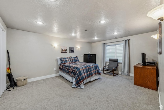 bedroom with a textured ceiling, carpet, baseboards, and recessed lighting