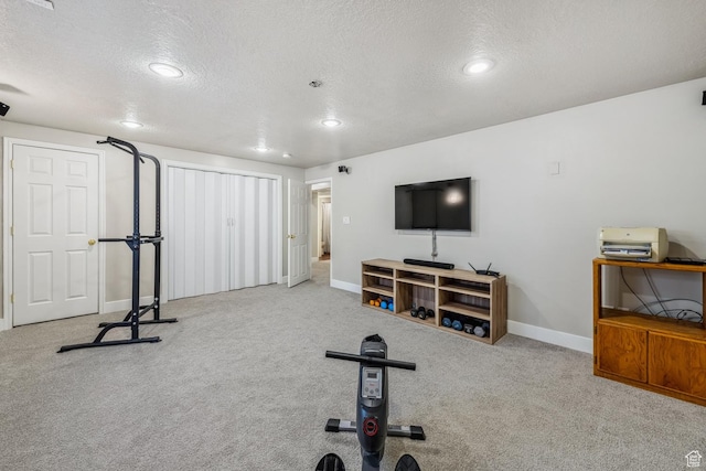 workout room with a textured ceiling, baseboards, carpet flooring, and recessed lighting