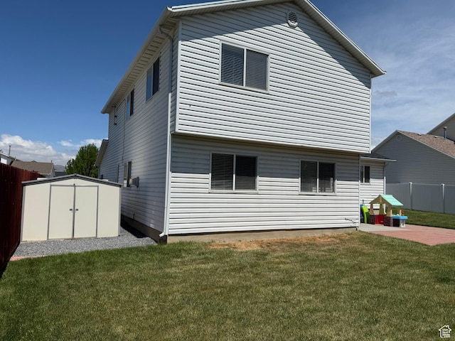 back of property with a storage unit, a patio area, and an outbuilding