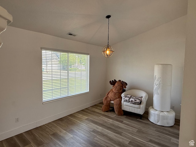 living area featuring wood finished floors and baseboards