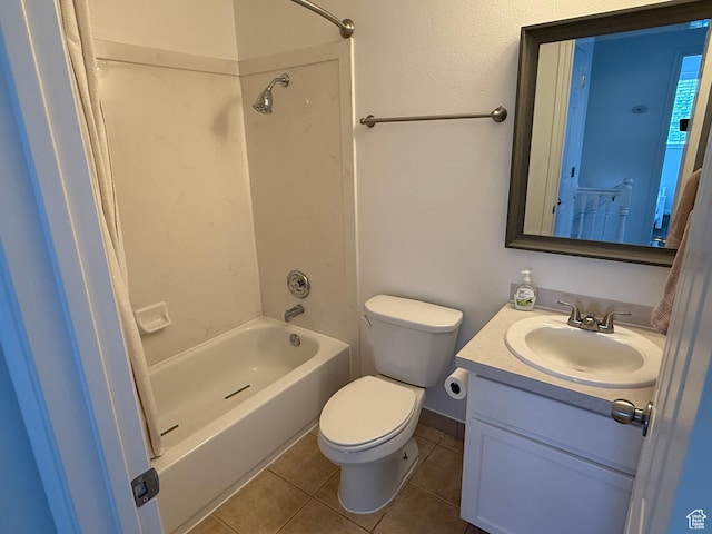 bathroom with tile patterned flooring, toilet, vanity, and shower / washtub combination