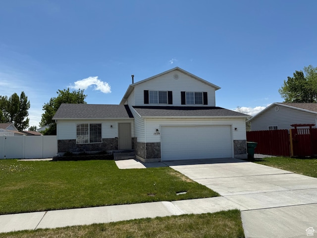 view of front of property with driveway, stone siding, and a garage