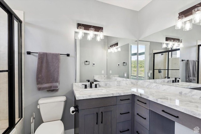 full bath with toilet, an enclosed shower, and double vanity