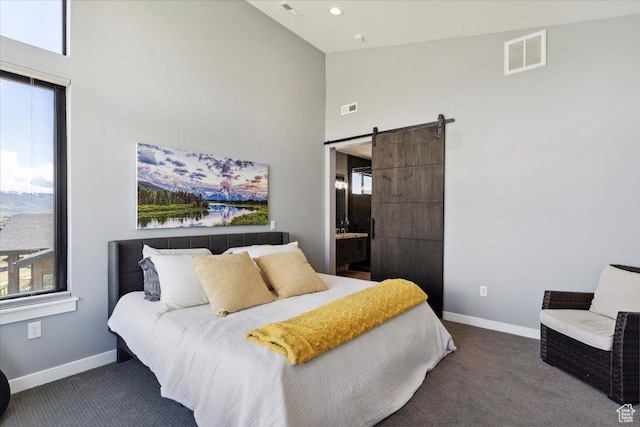 bedroom with carpet flooring, high vaulted ceiling, baseboards, a barn door, and connected bathroom