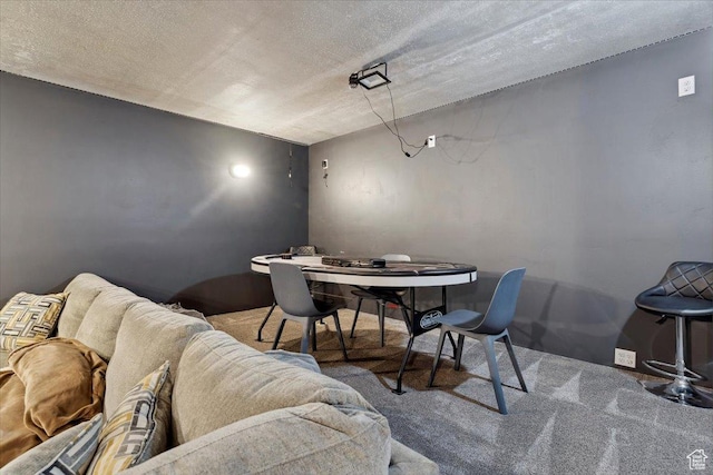 dining area featuring carpet flooring and a textured ceiling