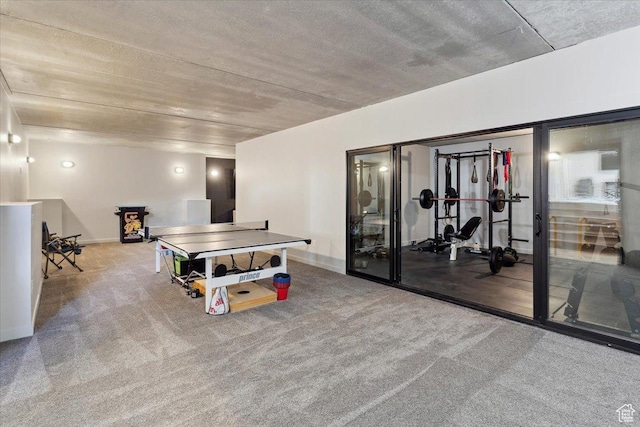 rec room featuring carpet floors and baseboards