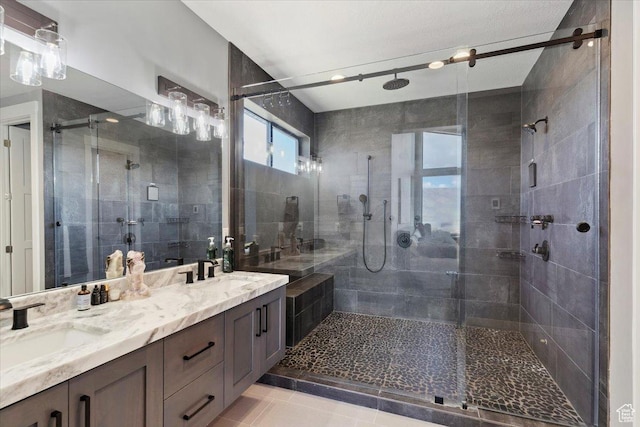 bathroom featuring a shower stall and double vanity