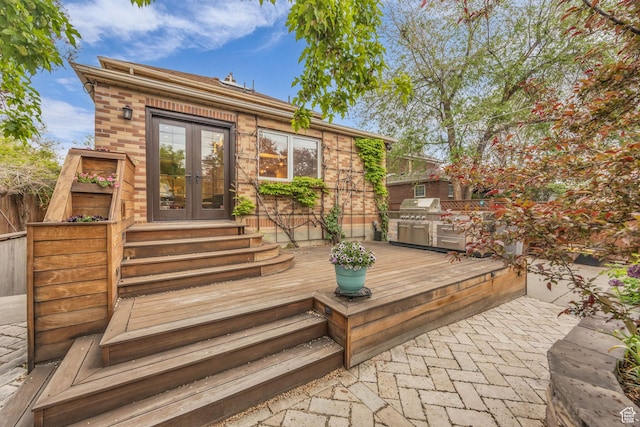 wooden deck featuring french doors, fence, and grilling area