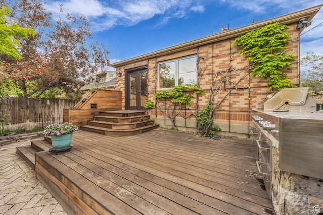 wooden deck featuring french doors and fence