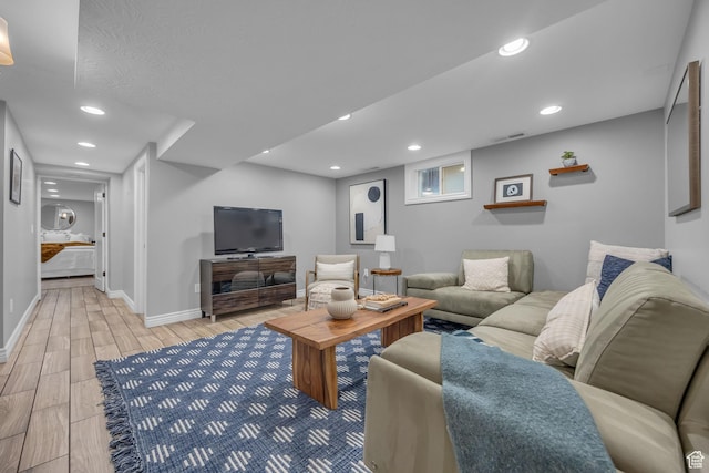 living area with wood finish floors, baseboards, and recessed lighting