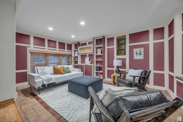 living area with recessed lighting, built in features, and baseboards