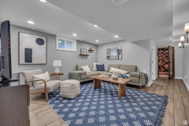 living area featuring light wood-type flooring, recessed lighting, and baseboards