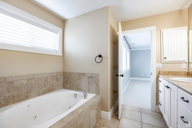 bathroom featuring a whirlpool tub, vanity, tile patterned flooring, and baseboards