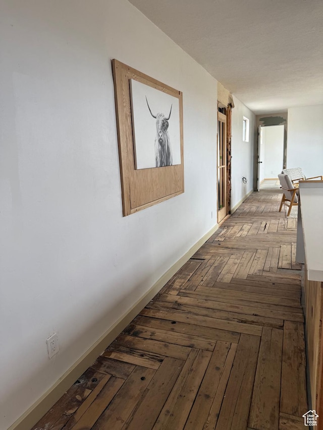 hall featuring baseboards
