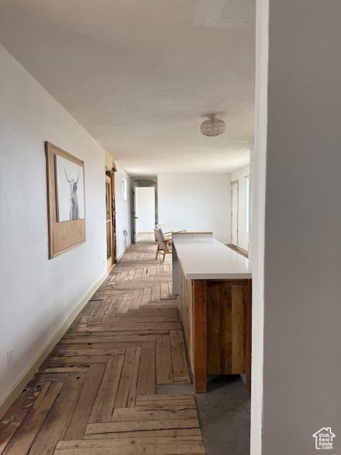 hall featuring baseboards