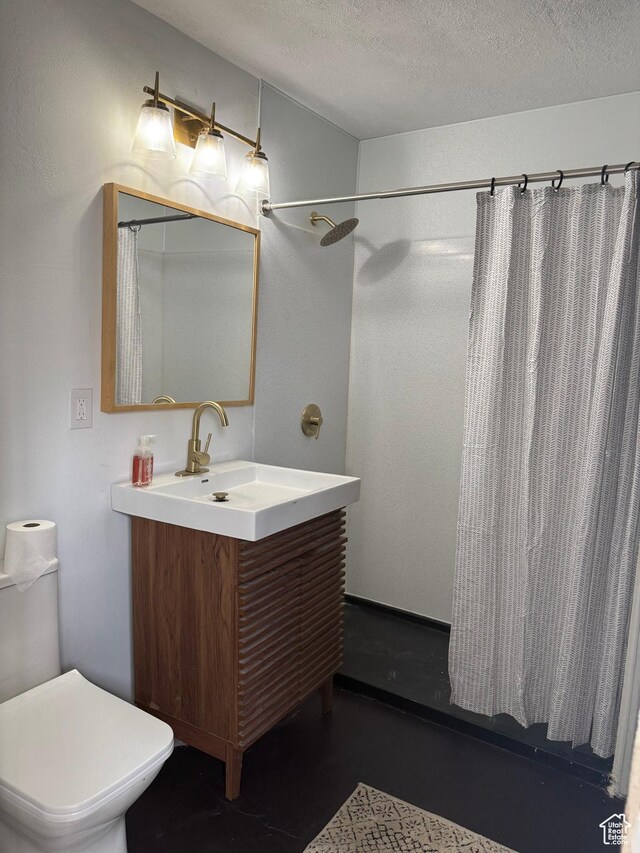 bathroom with a textured ceiling, vanity, a shower with curtain, toilet, and concrete floors