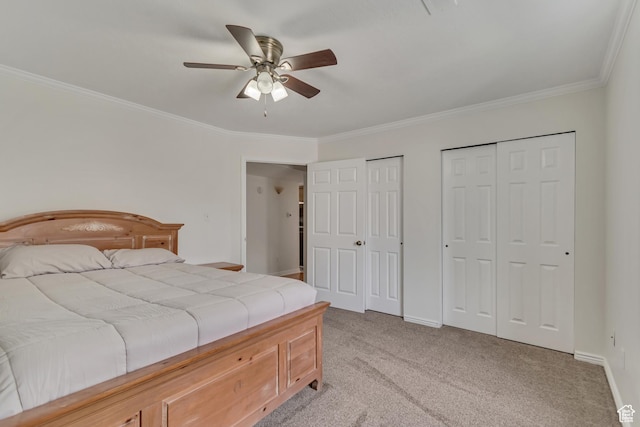 bedroom with multiple closets, ornamental molding, light carpet, baseboards, and a ceiling fan