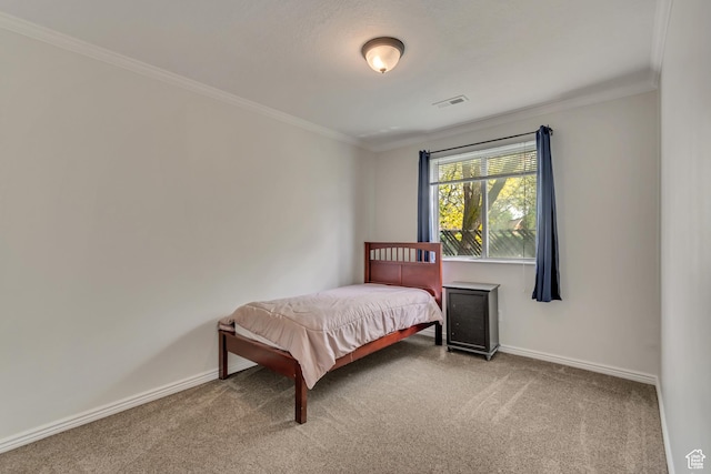 bedroom featuring carpet, crown molding, and baseboards