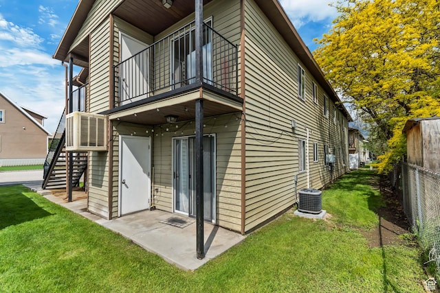 rear view of house with a balcony, stairs, a patio, and central AC