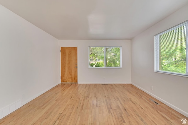 3410 S 2000 E, Millcreek, UT 84109 - spare room featuring healthy amount of natural light, light wood finished floors, and baseboards