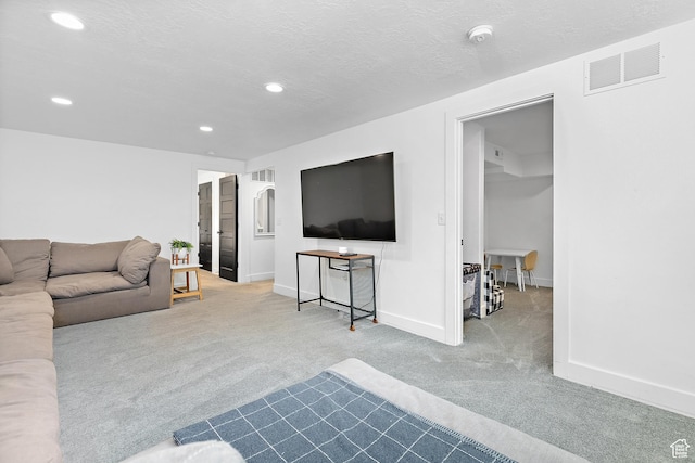 carpeted living area featuring recessed lighting and baseboards