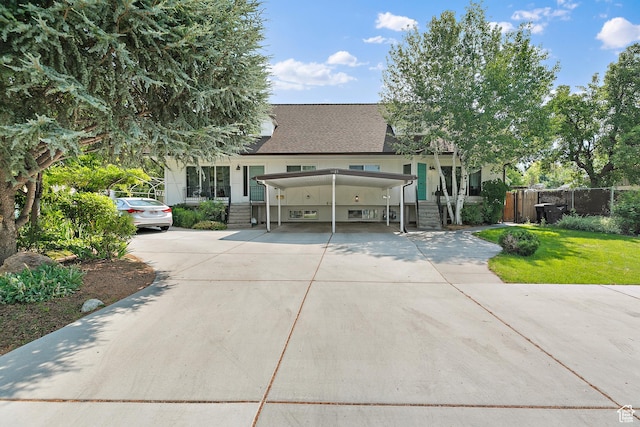 view of front of house with concrete driveway, a carport, and a shingled roof