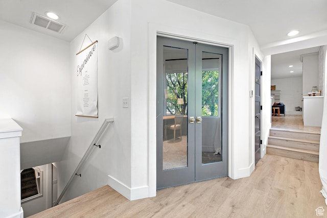 doorway to outside featuring french doors, wood finished floors, baseboards, and recessed lighting