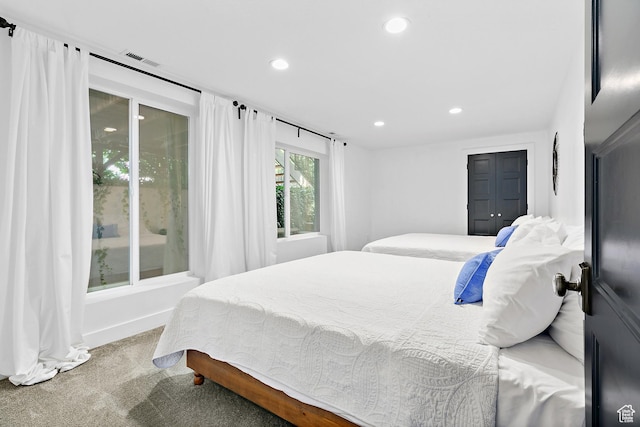 carpeted bedroom featuring recessed lighting