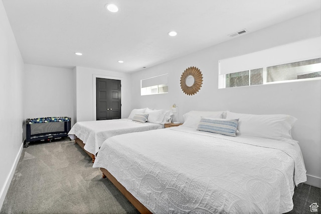 carpeted bedroom featuring baseboards, multiple windows, and recessed lighting
