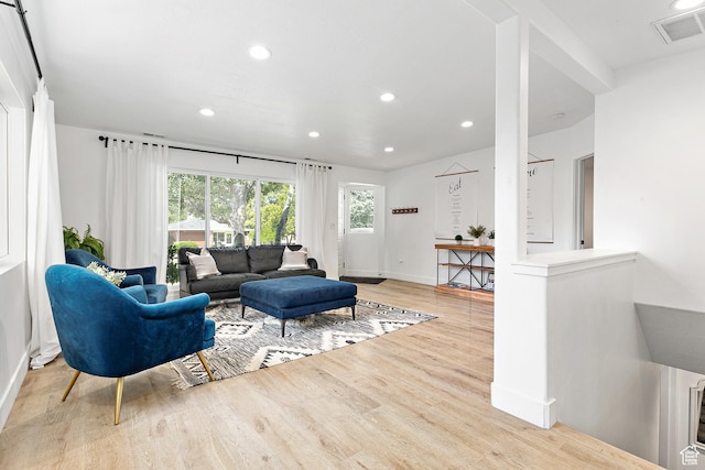living room with wood finished floors, recessed lighting, and baseboards