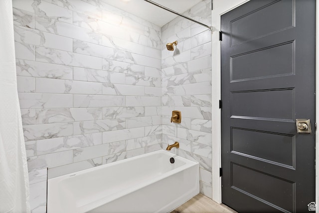bathroom with shower / bathtub combination with curtain and wood finished floors