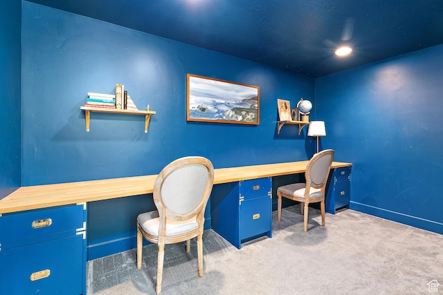 carpeted home office featuring baseboards