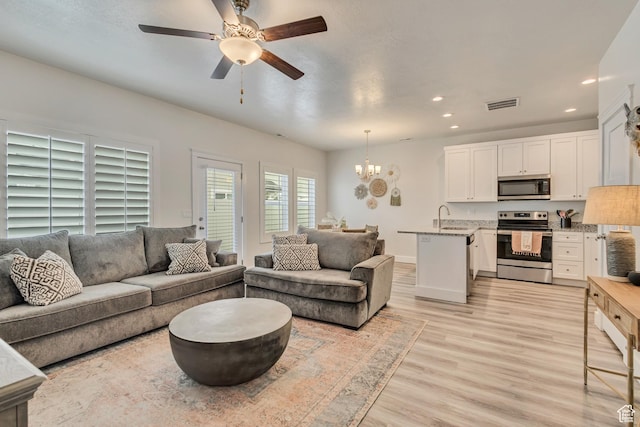 341 N 100 W, Morgan, UT 84050 - living room featuring recessed lighting, light wood finished floors, a chandelier, a ceiling fan, and baseboards