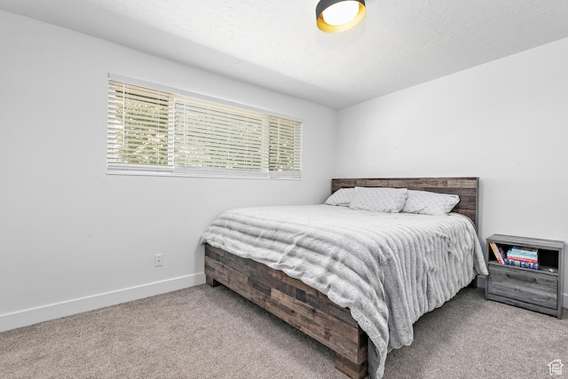 bedroom featuring carpet floors and baseboards