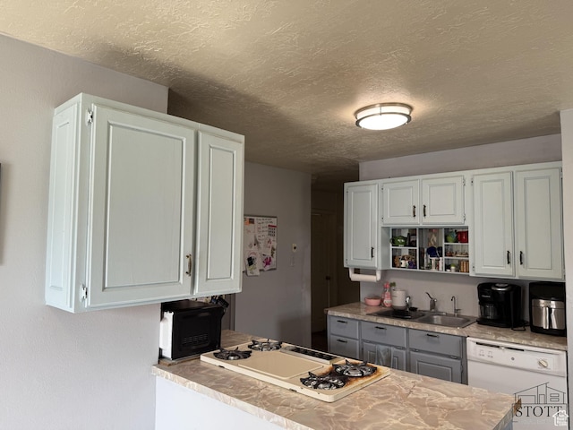380 N 100 W, Spanish Fork, UT 84660 - kitchen with white appliances, a textured ceiling, a sink, light countertops, and white cabinets