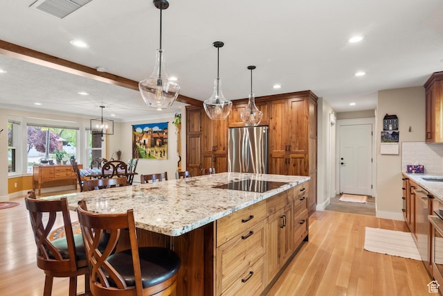 kitchen with freestanding refrigerator, black electric cooktop, baseboards, recessed lighting, and light wood-style flooring