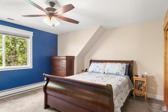 bedroom featuring carpet flooring, a baseboard heating unit, baseboards, a ceiling fan, and a textured ceiling