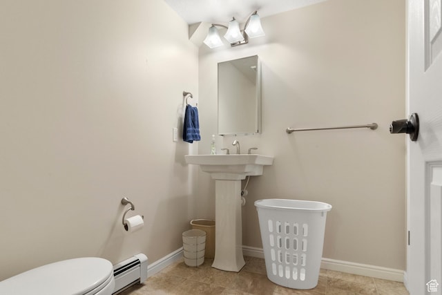 bathroom featuring a baseboard radiator, toilet, tile patterned flooring, and baseboards
