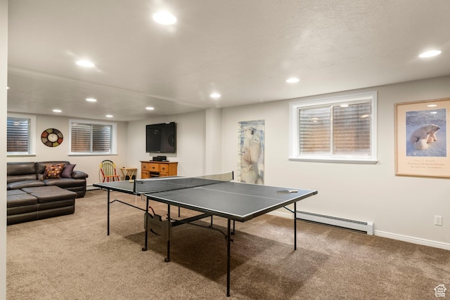 playroom featuring light carpet, recessed lighting, a baseboard heating unit, and baseboards