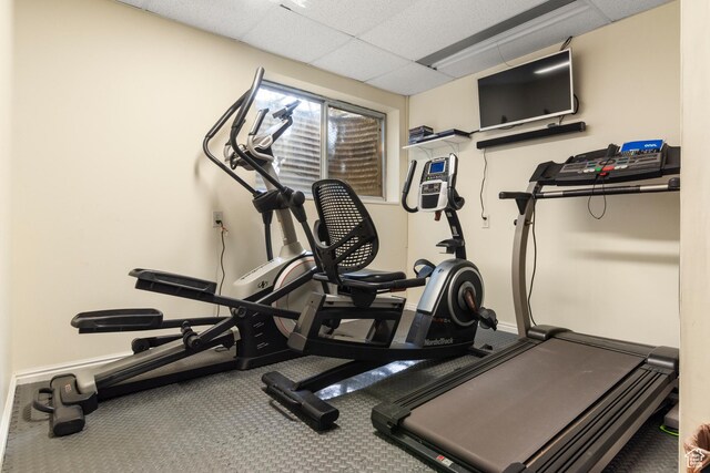 workout area featuring a paneled ceiling