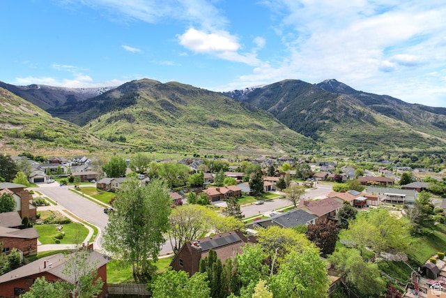view of mountain backdrop featuring nearby suburban area