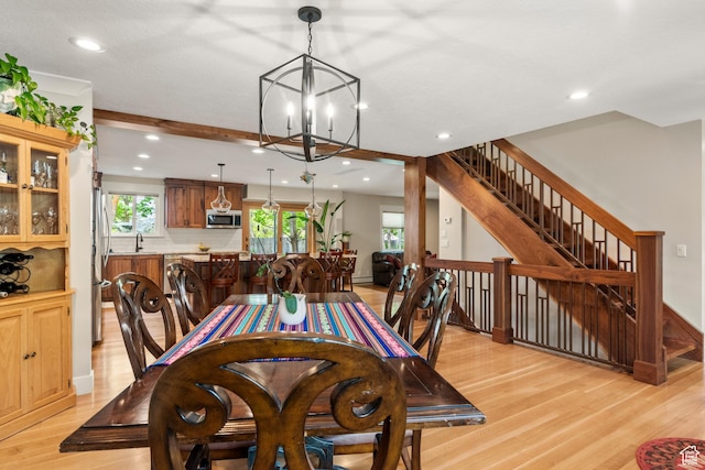dining room with a chandelier, light wood-style floors, recessed lighting, and stairs