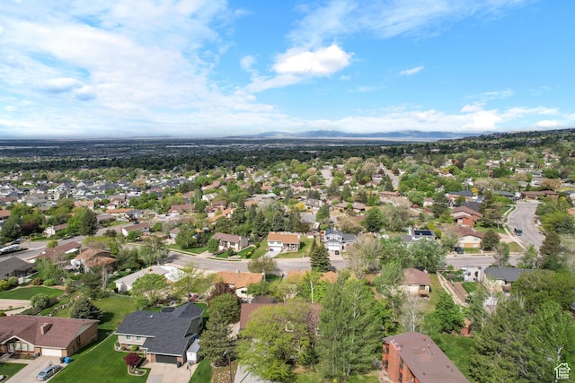 aerial view of property's location with nearby suburban area and mountains