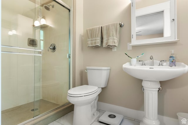 bathroom featuring toilet and a stall shower