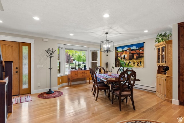 dining room with a chandelier, light wood-type flooring, a textured ceiling, recessed lighting, and baseboards