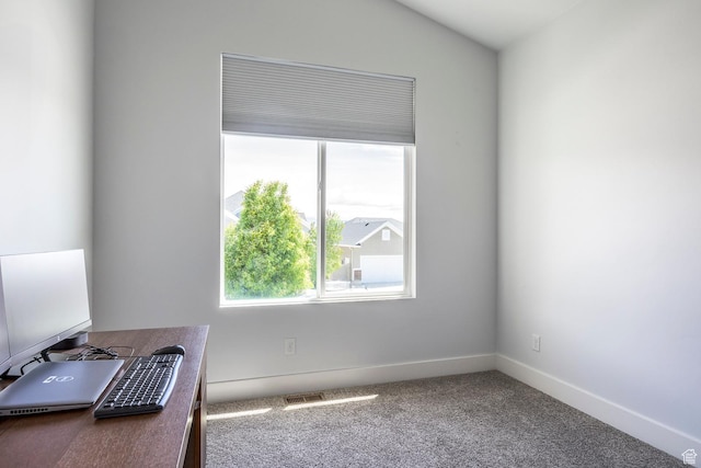 empty room with healthy amount of natural light, carpet flooring, baseboards, an office area, and lofted ceiling