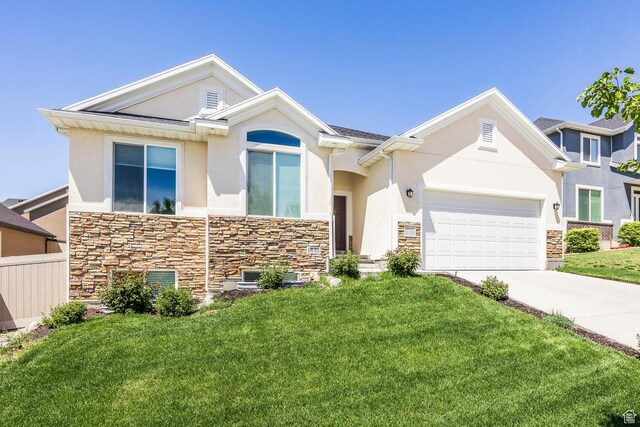 view of front of property featuring stone siding, stucco siding, concrete driveway, and a front lawn
