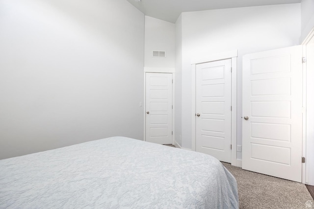 bedroom with carpet floors, a closet, and vaulted ceiling